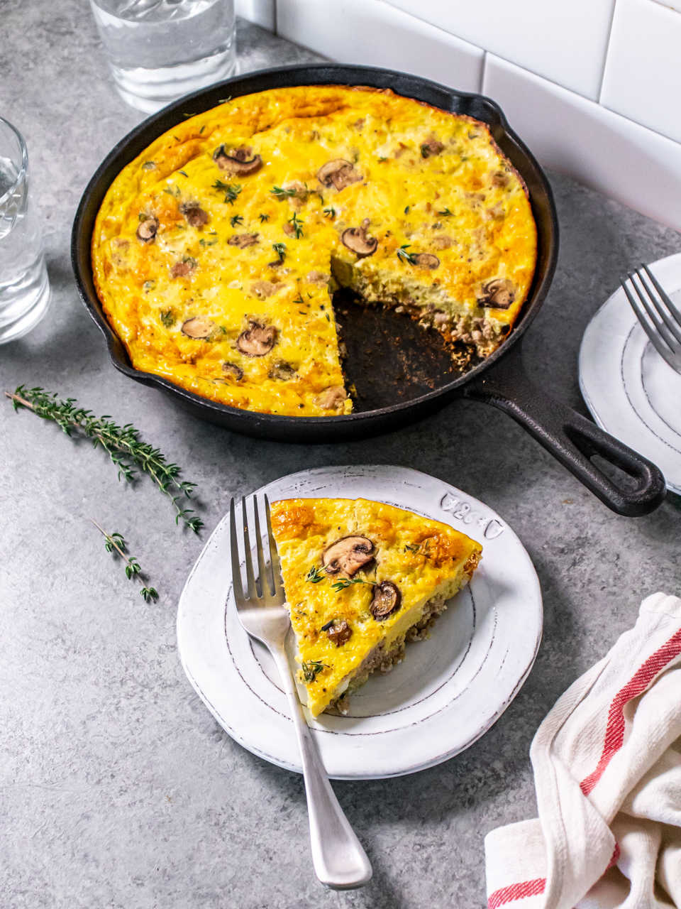 Protein packed mushroom frittata in a pan with the slice cut out.
